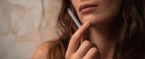 The Elegant Woman Holding a Cigarette in a Thoughtful Pose photo