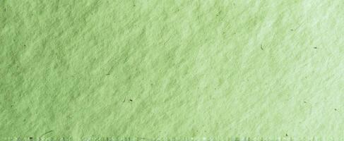 The textured green paper background creating a soothing and natural ambiance. photo
