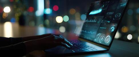 The modern laptop illuminated by city lights with hands engaged in data analysis. photo
