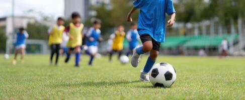 The young soccer player dribbling the ball in a dynamic outdoor game. photo