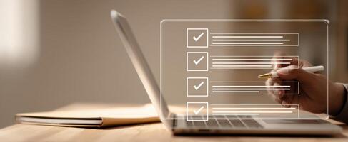 The digital checklist over a laptop for efficient task management and productivity photo