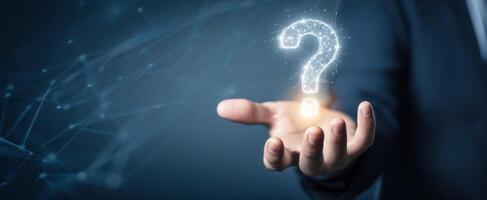 The glowing question mark in a businessman's hand symbolizing inquiry and innovation. photo