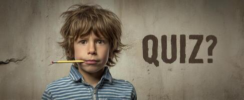 The inquisitive child pondering a quiz with a pencil in his mouth. photo