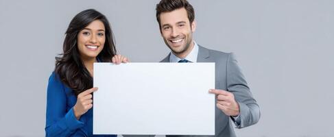 The happy couple presenting a blank sign for advertisement and marketing purposes. photo