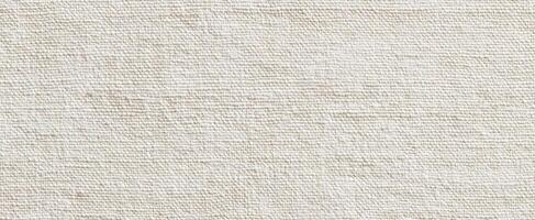 The textured canvas background in a soft beige color for creative designs photo