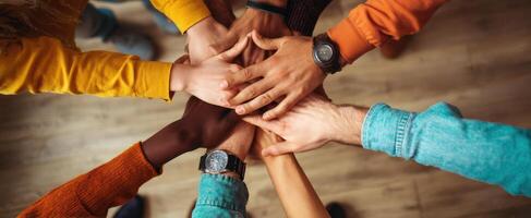 The hands of teamwork united in a gesture of collaboration and support. photo