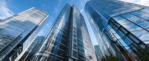 The stunning glass skyscrapers reaching towards the blue sky in an urban setting. photo