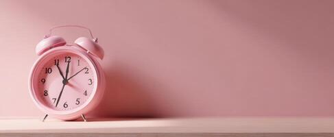 The pink alarm clock inviting a serene morning ambiance on a minimalistic background. photo