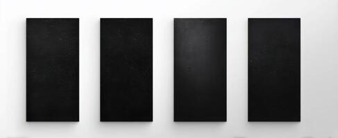 The series of four sleek black canvases on a white wall photo