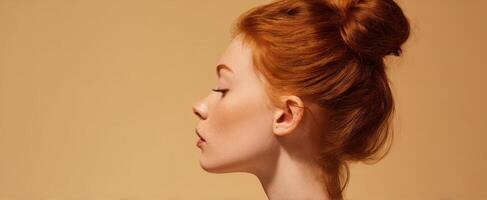 The elegant woman in profile showcasing a chic hairstyle against a warm background. photo