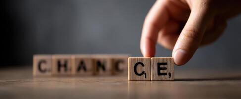 The Hand Placing Wooden Blocks to Spell Out Change and Opportunity photo