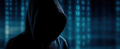 The hooded figure representing anonymity in the digital age. photo