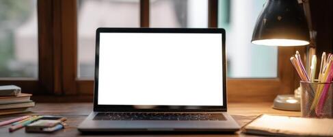 The stylish laptop on a cozy workspace with natural light and stationery. photo