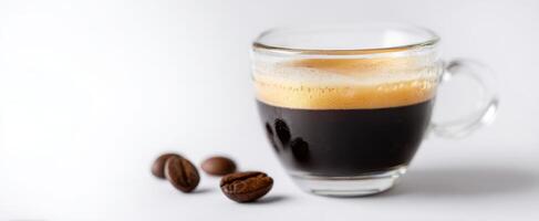 The aromatic espresso served in a stylish glass cup with coffee beans. photo