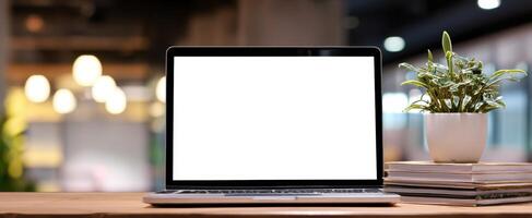The laptop displaying a blank screen in a cozy modern workspace. photo
