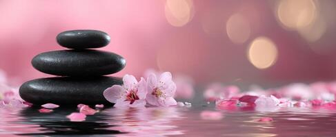 The tranquil stones balanced on water with delicate cherry blossoms. photo