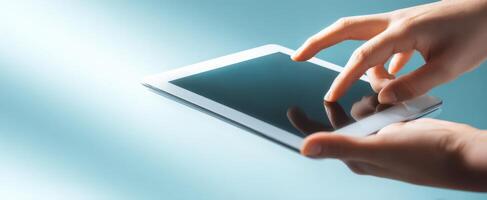 The hands interacting with a tablet device against a sleek modern background. photo