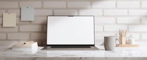 The sleek laptop and minimalist workspace with coffee and stationery on the desk. photo