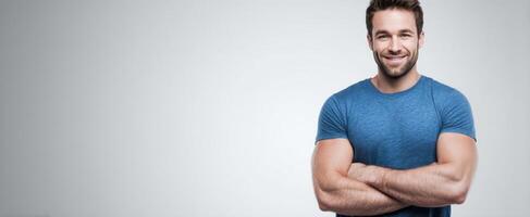 The confident man smiling with crossed arms in a casual setting photo