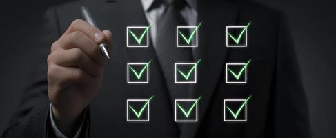 The businessman checking off completed tasks on a digital checklist. photo