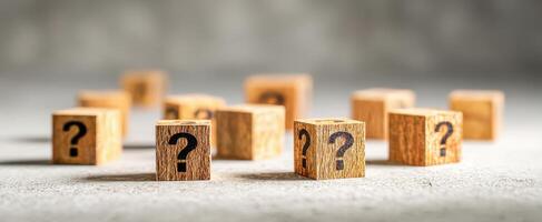 The wooden blocks with question marks representing uncertainty and curiosity in decision-making. photo