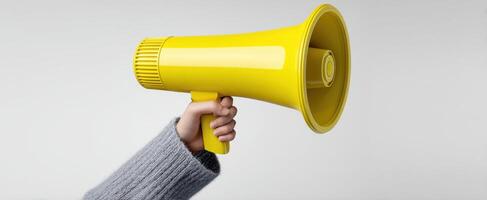 The yellow megaphone held high to amplify voices and messages. photo