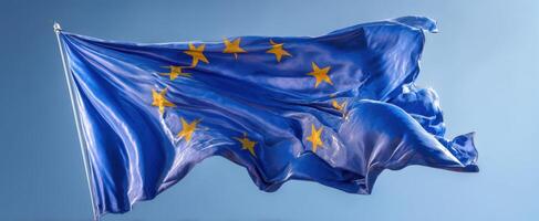 The European Union Flag Waving Gracefully Against a Sky Background photo