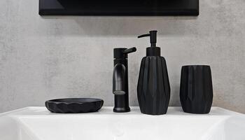 Black faucet, ceramic bottles for soap or shampoo and glass for toothbrushes or mouthwash on white shelf for sale. Object on gray wall background with copy space. photo