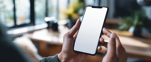 The smartphone held in hands with a blank screen ready for use. photo