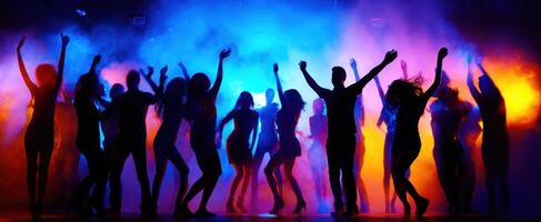 The vibrant dance party with silhouettes against colorful lights and smoke. photo