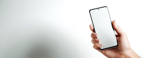 The smartphone held in hand against a clean, white background. photo
