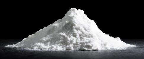 The fine white powder with a soft, fluffy texture against a dark background. photo