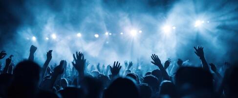The Energetic Crowd at a Live Concert Under Blue Lights photo