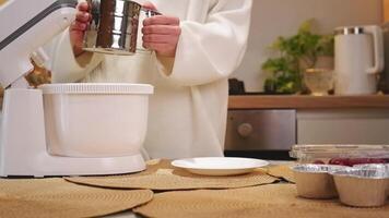 Pastry chef sifting flour into a stand mixer video
