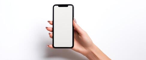 The smartphone held in a hand with a blank screen for mockup purposes. photo