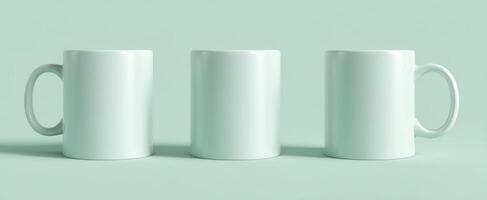 The elegant trio of blank mugs on a soft mint background. photo