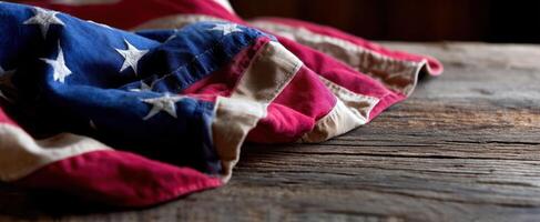 The American flag elegantly draped over a rustic wooden surface. photo