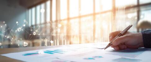 The hand writing on a financial report with digital analytics overlay. photo