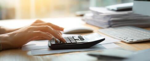 The calculator in use while managing financial documents on a busy office desk. photo