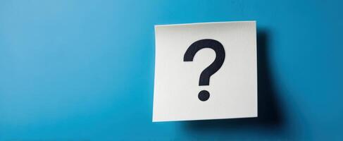 The Blank Note with a Question Mark on a Blue Background photo