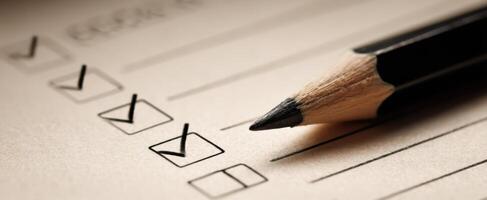 The detailed checklist with a sharpened pencil ready for completion. photo