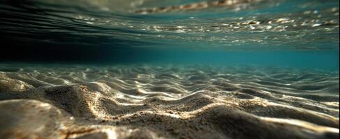 The tranquil underwater scene revealing sandy textures and gentle light. photo