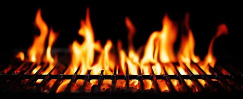 The intense flames dancing over a grill in a darkened environment. photo