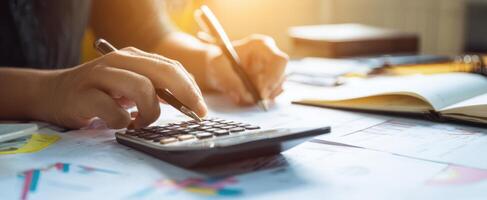 The calculator and hands analyzing financial documents in a professional workspace. photo
