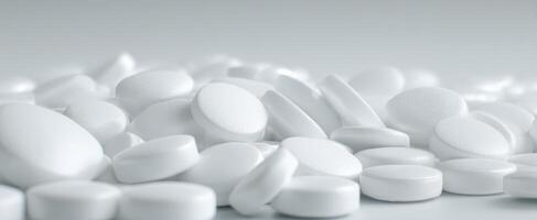 The collection of white pills on a minimalistic surface showcasing health and wellness. photo