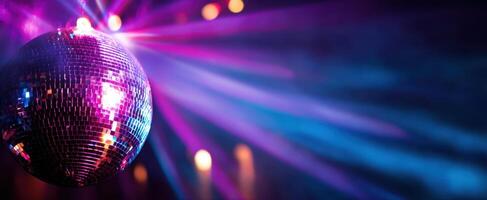 The dazzling disco ball reflecting vibrant lights at a lively party atmosphere. photo