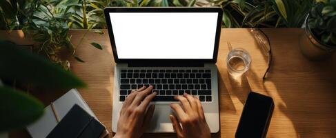 The laptop displaying a blank screen in a cozy indoor workspace. photo