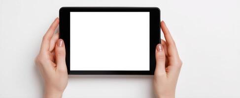 The tablet held in hands with a blank screen ready for creativity. photo