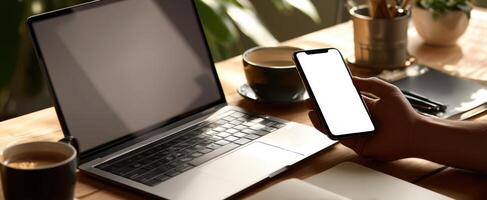The smartphone and laptop creating a modern work environment with coffee. photo