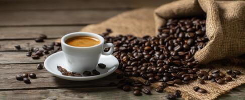 The aromatic coffee cup surrounded by freshly roasted coffee beans. photo